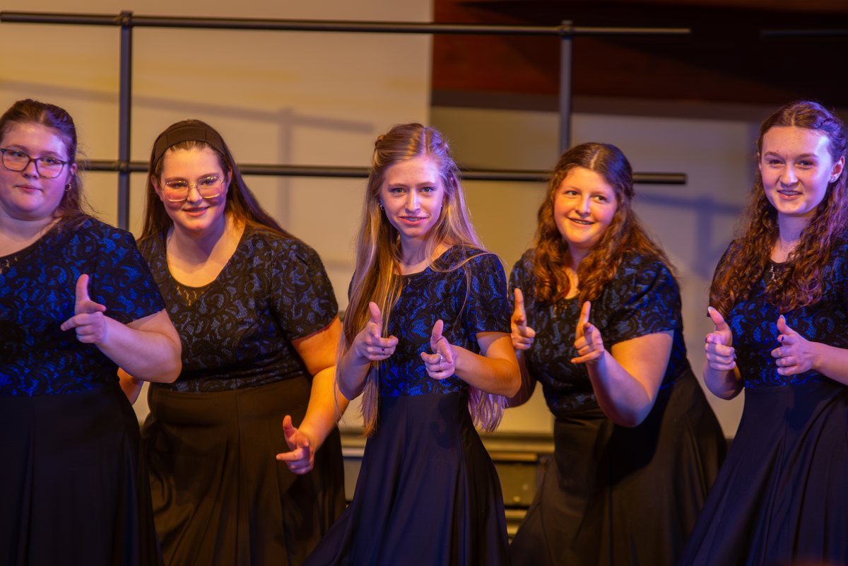 Show choir singers performing with hand motions