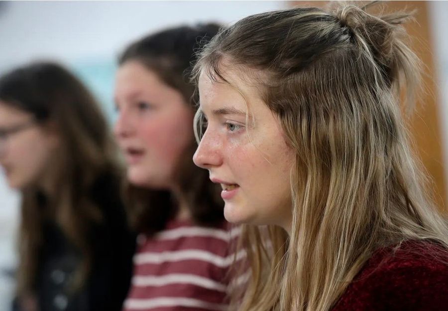 Teen choir members singing