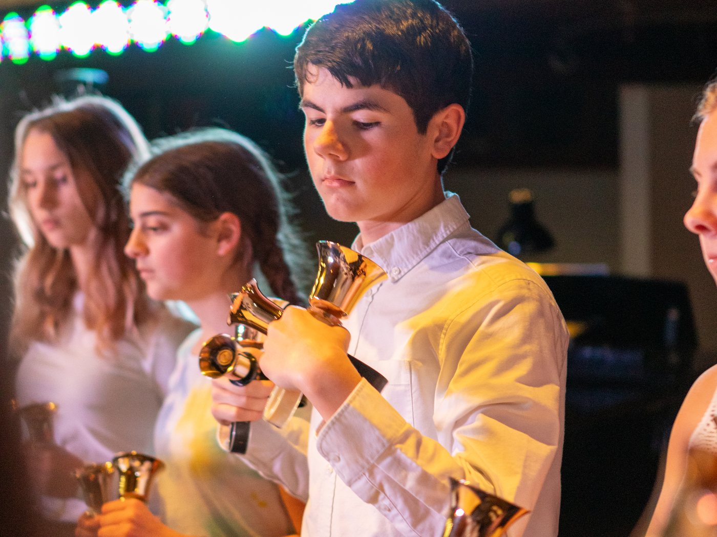 Students ringing handbells in concert