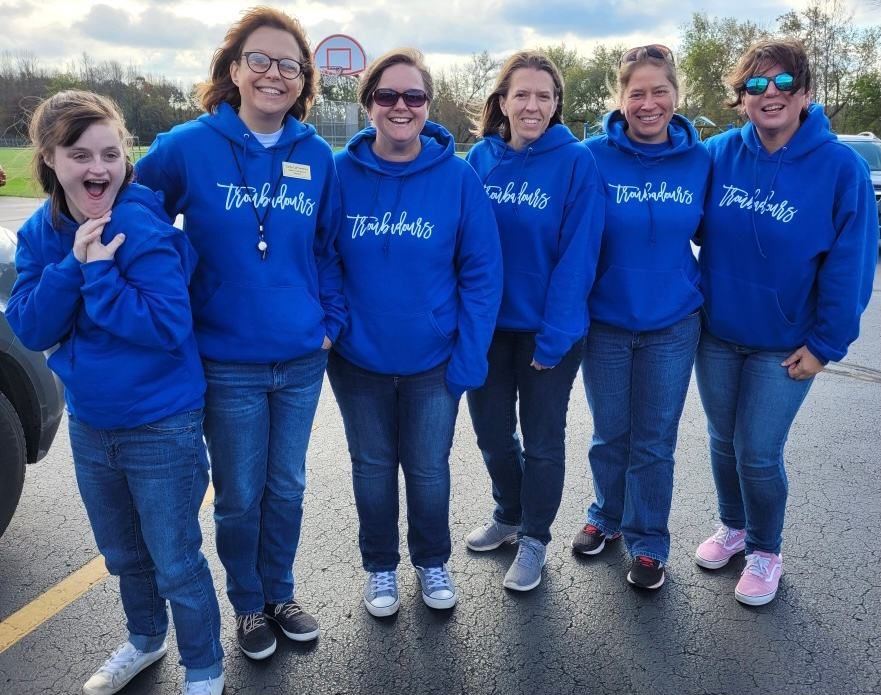 Troubadours staff in blue Troubadours sweatshirts
